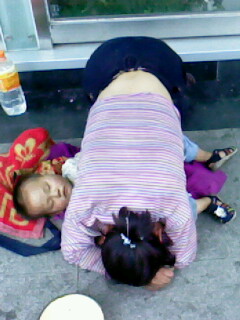 洛阳黑镜头：工贸天桥上乞讨女人身下熟睡的乞讨小孩，疑似被用安眠药